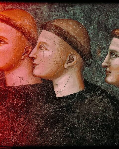 Detail of a medieval fresco showing three tonsured monks in profile.