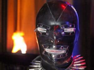 Futuristic robot head with glowing red eyes and zippers