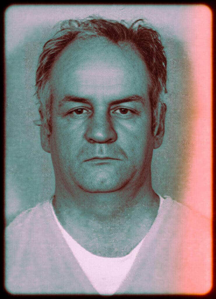 Portrait of a man with a serious expression, emphasizing human darkness.