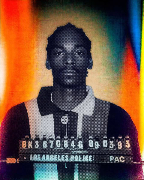 Colourised booking photo of rapper Snoop Dogg facing the camera above a booking number board dated 09-03-93.