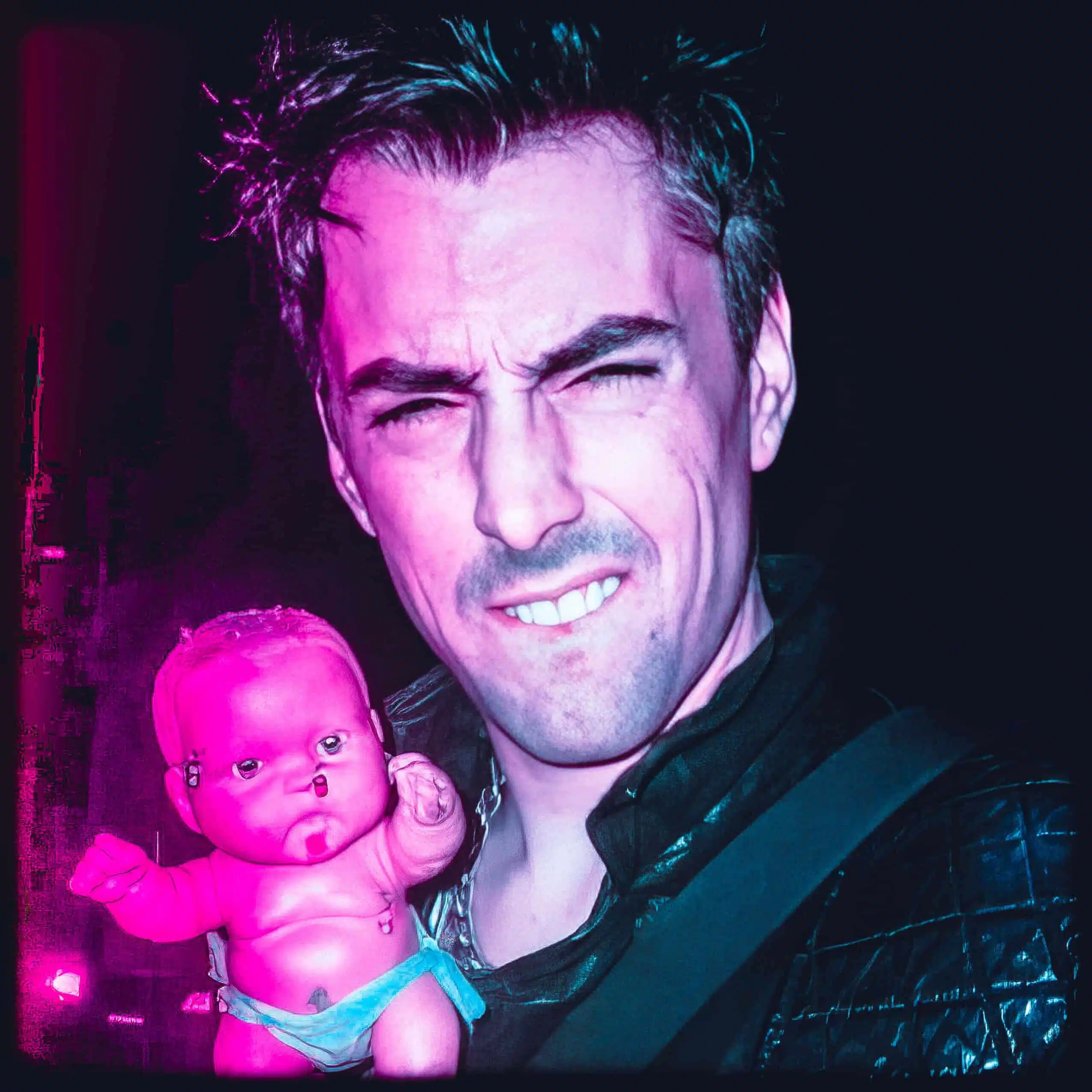 Eerie Image Of A Man Holding A Disturbing Doll With Neon Lighting.