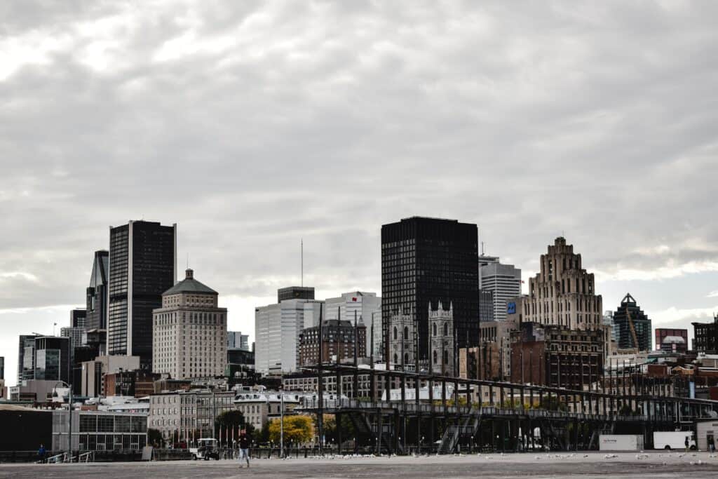 Montreal skyline and city buildings under a cloudy sky.