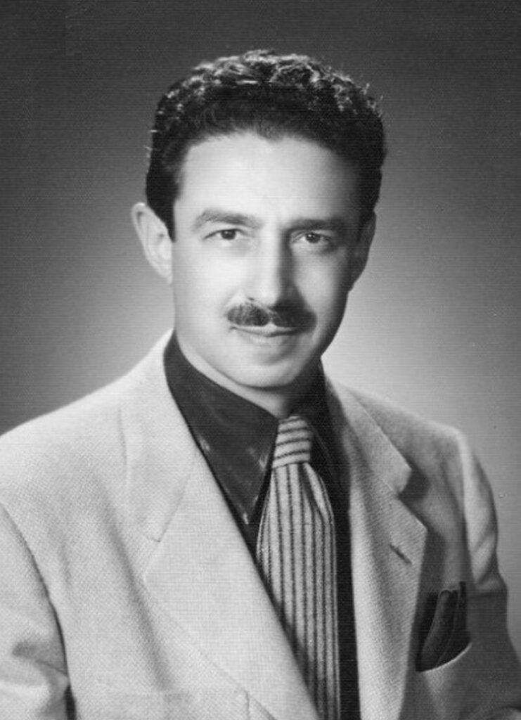 Black and white portrait of a man with a mustache in formal attire.