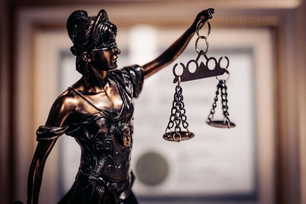 Bronze statue of Lady Justice with scales symbolizing justice and morality.