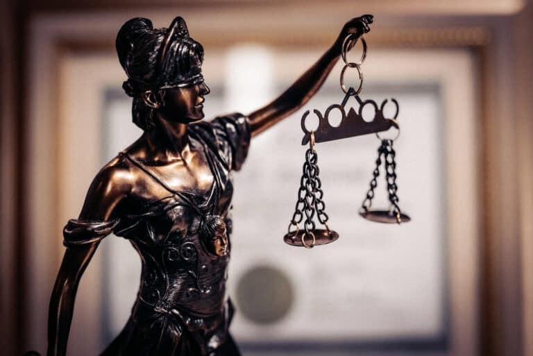 Bronze statue of Lady Justice with scales symbolizing justice and morality.