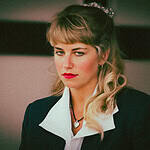 Portrait of a woman with a serious expression, representing the dark side of human nature.