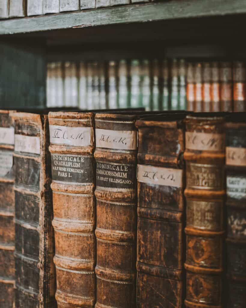 Antique psychology and medical books arranged on wooden shelves.