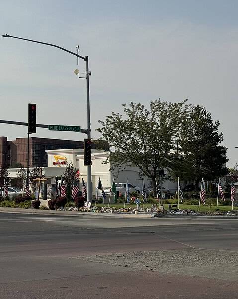 The Twin Falls In-N-Out on August 12, 2026, eleven days after the shooting, with memorial flags