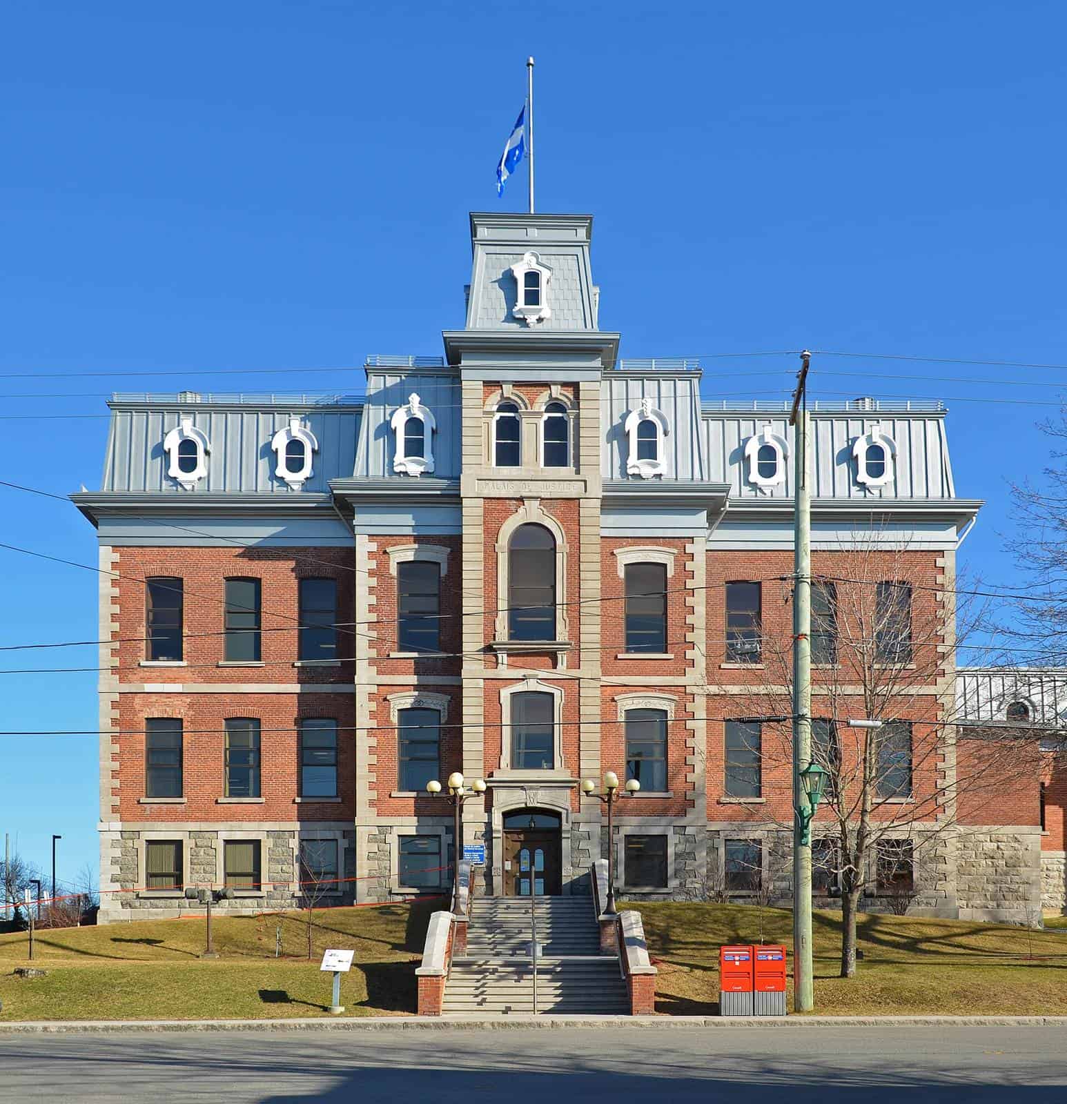 The red brick courthouse in Rivière-du-Loup, Quebec, under a clear sky