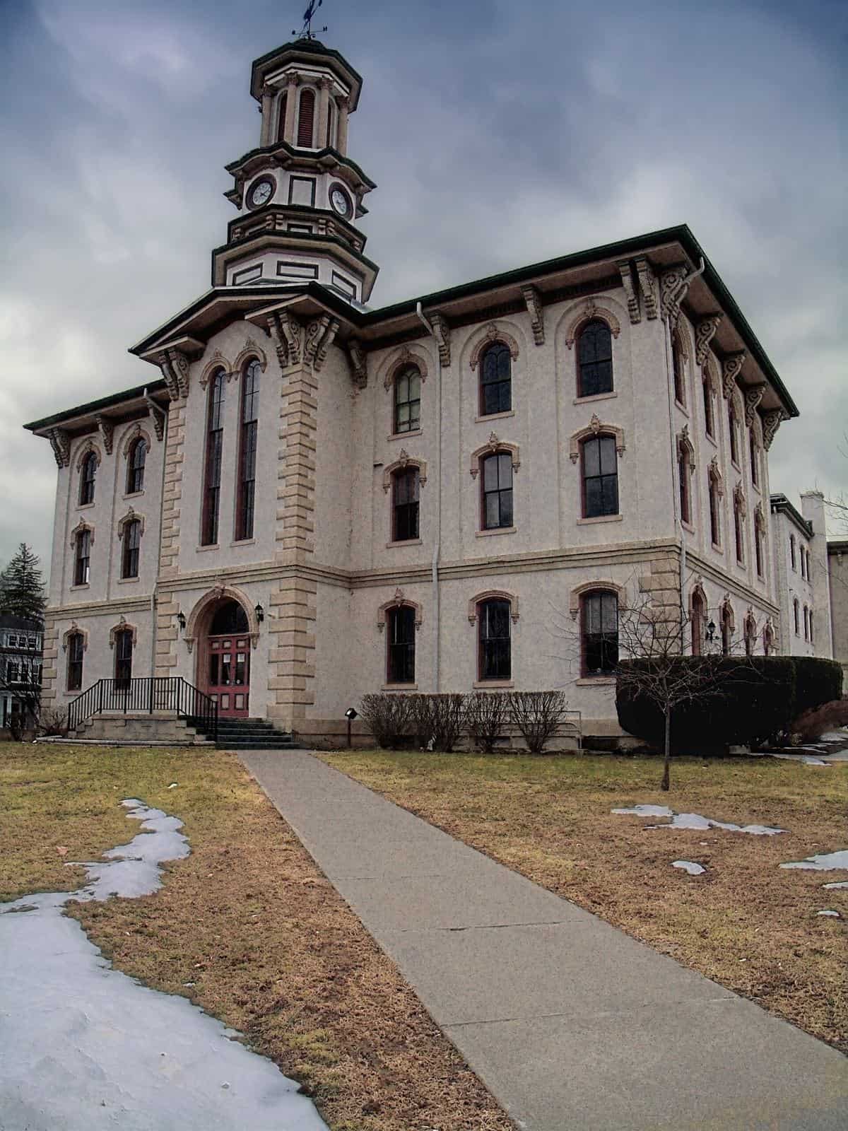 The pale Italianate Wyoming County Courthouse in Tunkhannock, Pennsylvania, with its clock tower, under a gray sky