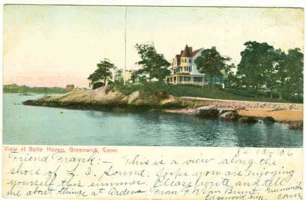 A 1906 hand tinted postcard showing a rocky shoreline at Belle Haven, Greenwich, with a large house among trees