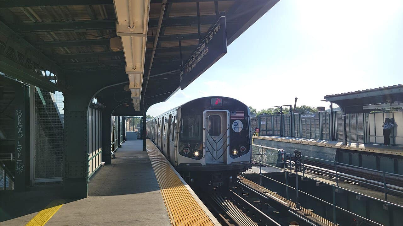 A J train arriving at the elevated Woodhaven Boulevard station in Queens
