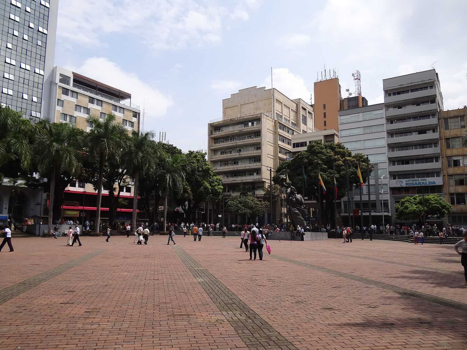 The Plaza de Bolívar in Pereira, an open paved square with trees and buildings around it.