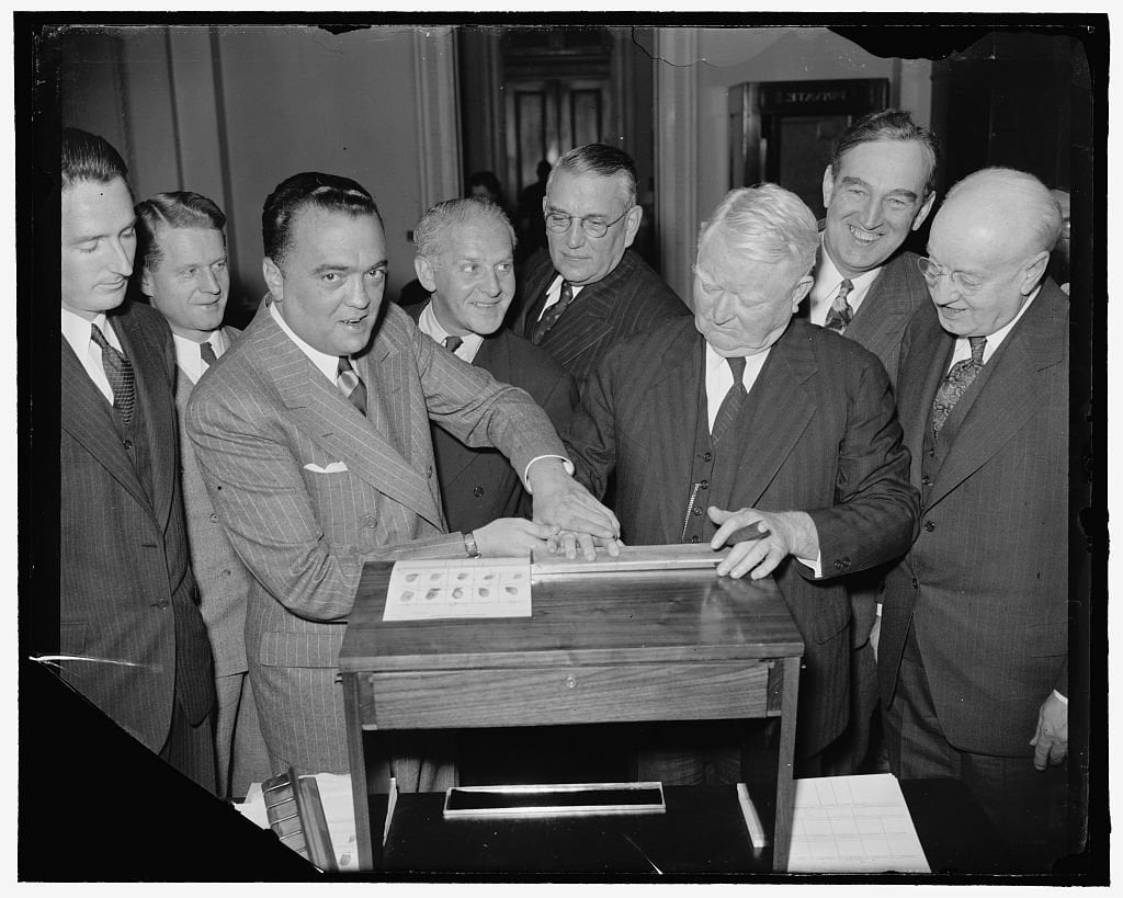 J. Edgar Hoover pressing the fingertips of Vice President John Nance Garner onto a fingerprint card