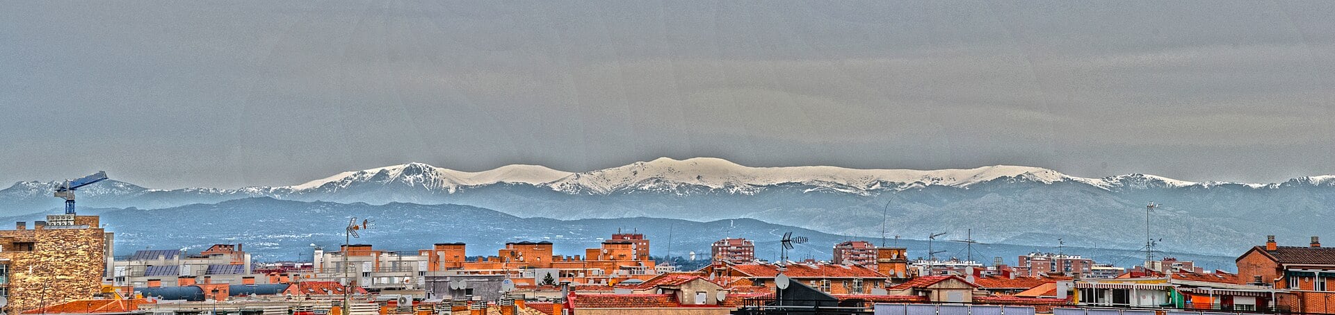 Rooftops of Carabanchel with mountains behind