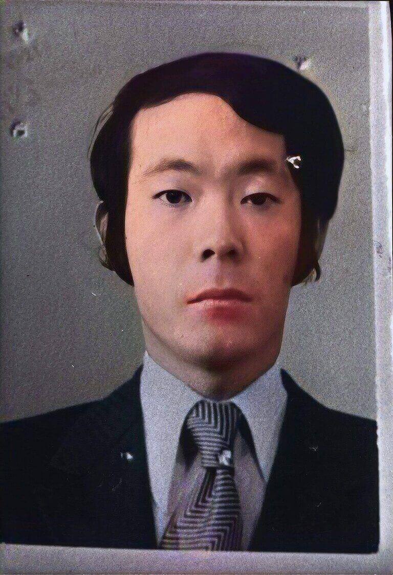 Close-up colourised portrait photograph of Issei Sagawa facing the camera.